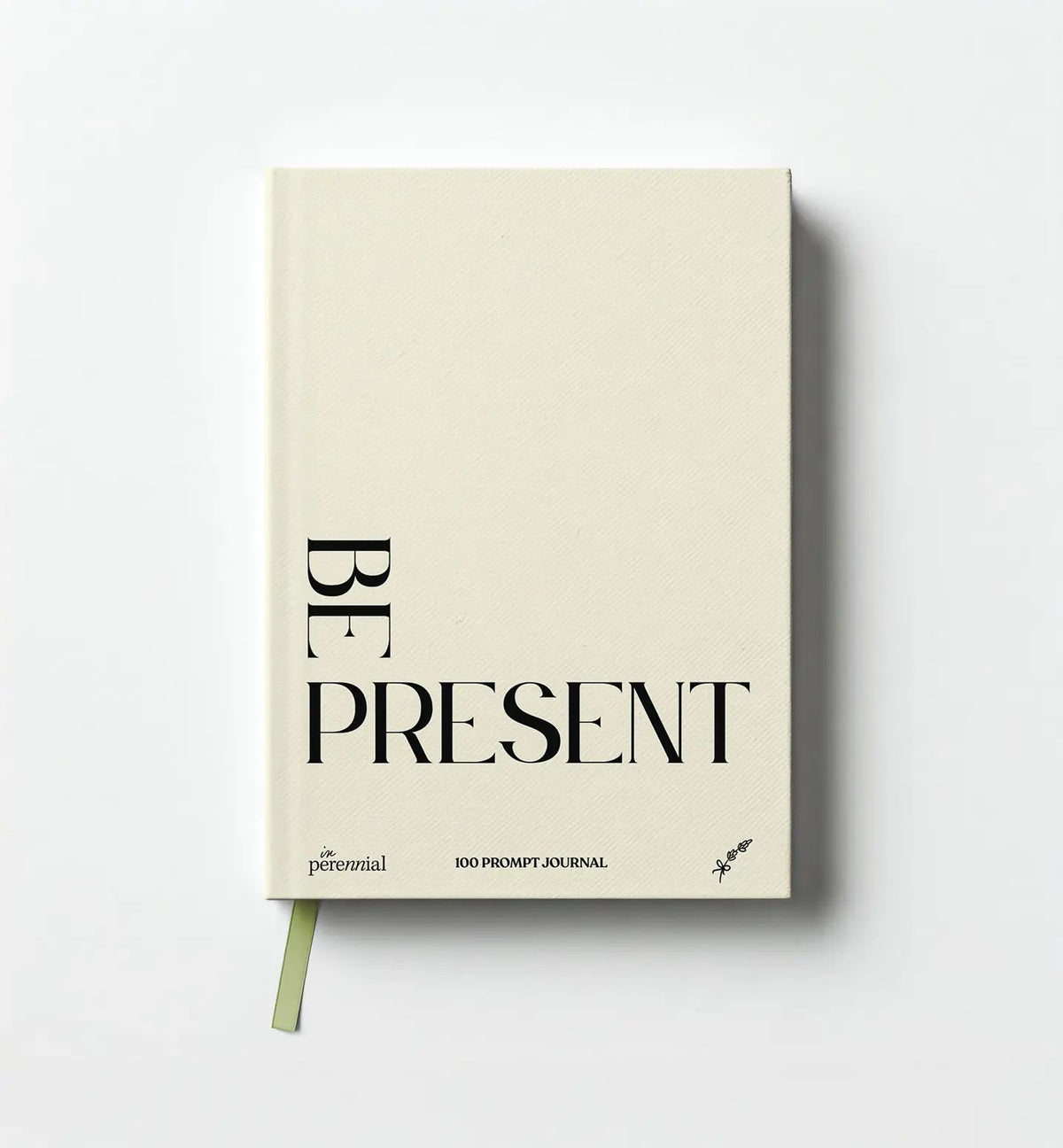 Front cover of in Perennial's beige Be Present 100 Prompt Journal, with black lettering and a green ribbon bookmark.