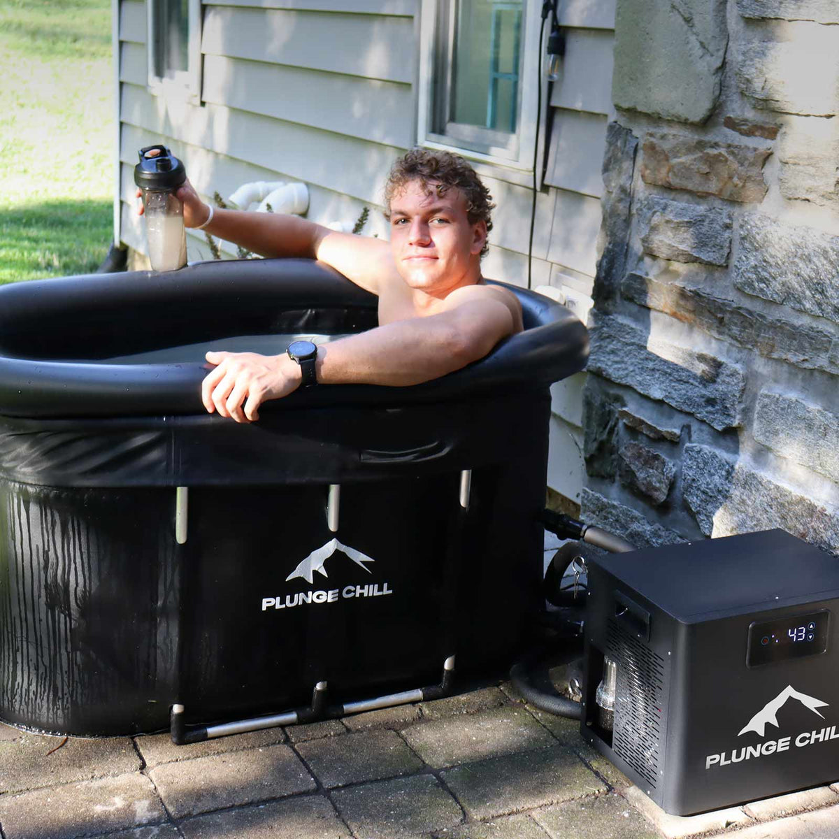 PLUNGE CHILL MAX tub in use outdoors with water bottle